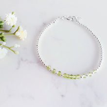Load image into Gallery viewer, Light green gemstones in the centre with sterling silver beads