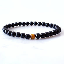 Load image into Gallery viewer, 6mm black obsidian bracelet with a tigers eye stone in the centre