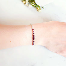 Load image into Gallery viewer, Deep red rubies in the centre of silver beads