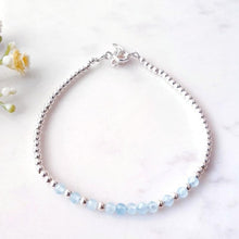 Load image into Gallery viewer, Light blue gemstone beaded bracelet in the centre of sterling silver beads