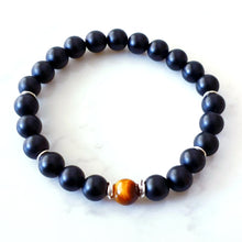 Load image into Gallery viewer, 8mm matt black agate bracelet with a tigers eye stone in the centre and sterling silver rings