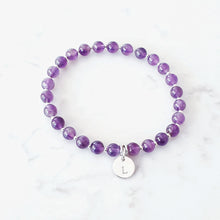 Load image into Gallery viewer, 6mm amethyst gemstone stretch bracelet with 10mm initial charm. Bracelet has small sterling silver beads inbetween.