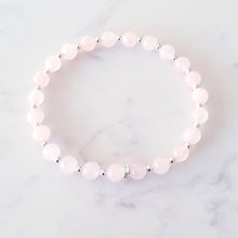 Load image into Gallery viewer, 6mm rose quartz beaded bracelet, with 3 linked rings in the centre and silver beads inbetween each gemstone - stretch fit