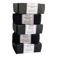 Load image into Gallery viewer, Stack of wax melts in black boxes 
