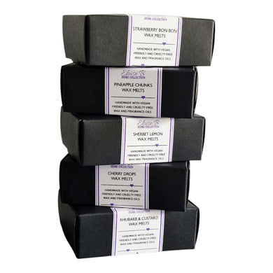 Stack of wax melts in black boxes 