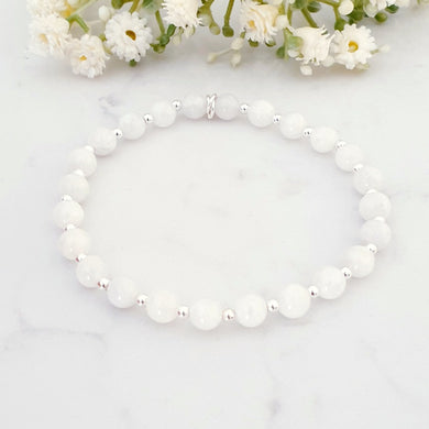 White beaded bracelet with alternating sterling silver beads