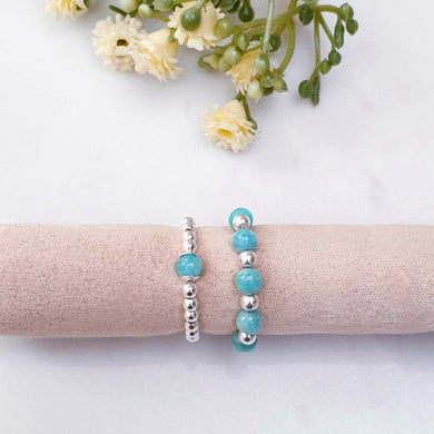 Light blue/green beaded stretch rings with sterling silver
