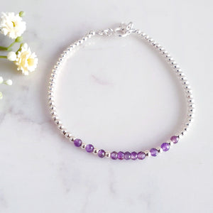 Amethyst beads in the centre of sterling silver beads