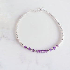 Amethyst gemstones in the centre of sterling silver beads