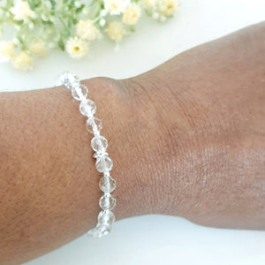 6mm faceted clear crystal quartz stretch bracelet with sterling silver beads and linked rings in the centre