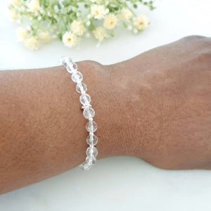 6mm faceted clear crystal quartz stretch bracelet with sterling silver beads with inked rings in the centre