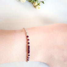 Load image into Gallery viewer, Rich  red  ruby gemstones in the centre of a silver bead bracelet
