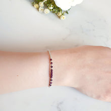 Load image into Gallery viewer, Deep red rubies in the centre of a silver beaded bracelet
