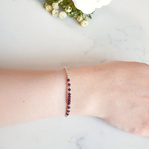 Deep red rubies in the centre of a silver beaded bracelet