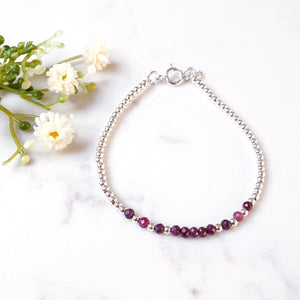 Faceted rubies in the centre with sterlng silver beads