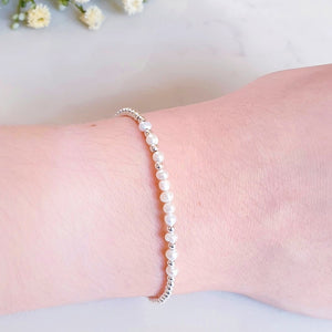 White freshwater pearl beads in the centre of round silver beads