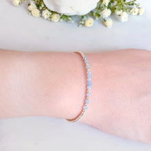 Load image into Gallery viewer, Light blue gemstones with sterling silver beads.  The gemstone beads are placed in the centre of the bracelet
