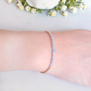 Light blue gemstones with sterling silver beads.  The gemstone beads are placed in the centre of the bracelet