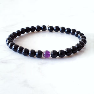 Black Obsidian with Amethyst centre bead with sterling silver rings.  Stretch bracelet