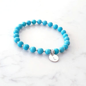 Blue Howlite bracelet with sterling silver beads inbetween and a personalised disc charm in centre with linked rings