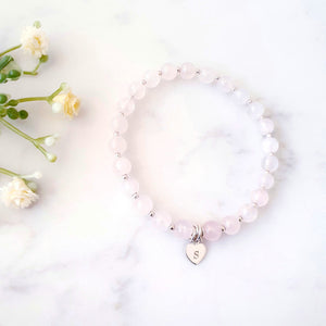 Rose quartz beaded bracelet with sterling silver beads inbetween and personalised heart charm