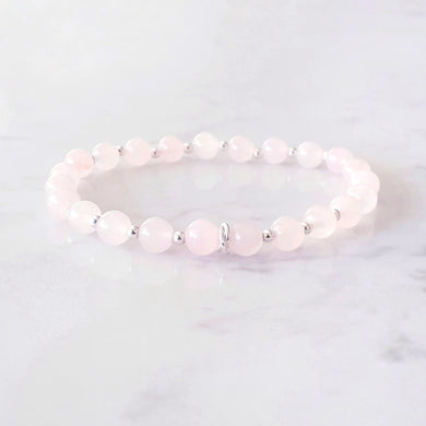 6mm rose quartz bracelet, with 3 linked rings in the centre and silver beads inbetween each gemstone