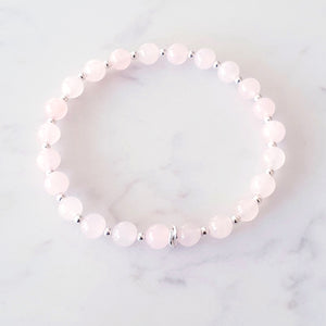 6mm rose quartz beaded bracelet, with 3 linked rings in the centre and silver beads inbetween each gemstone - stretch fit