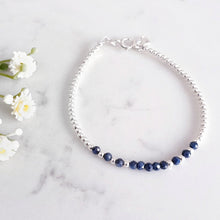 Load image into Gallery viewer, Deep blue sapphire bracelet in the centre of sterling silver beads
