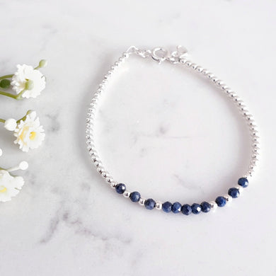 Deep blue sapphire bracelet in the centre of sterling silver beads