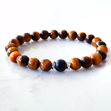8mm tigers eye bracelet with a matt black agate stone in the centre and sterling silver rings