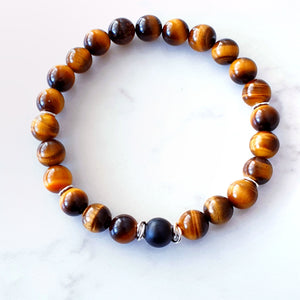 8mm tigers eye bracelet with a matt black agate stone in the centre and sterling silver rings